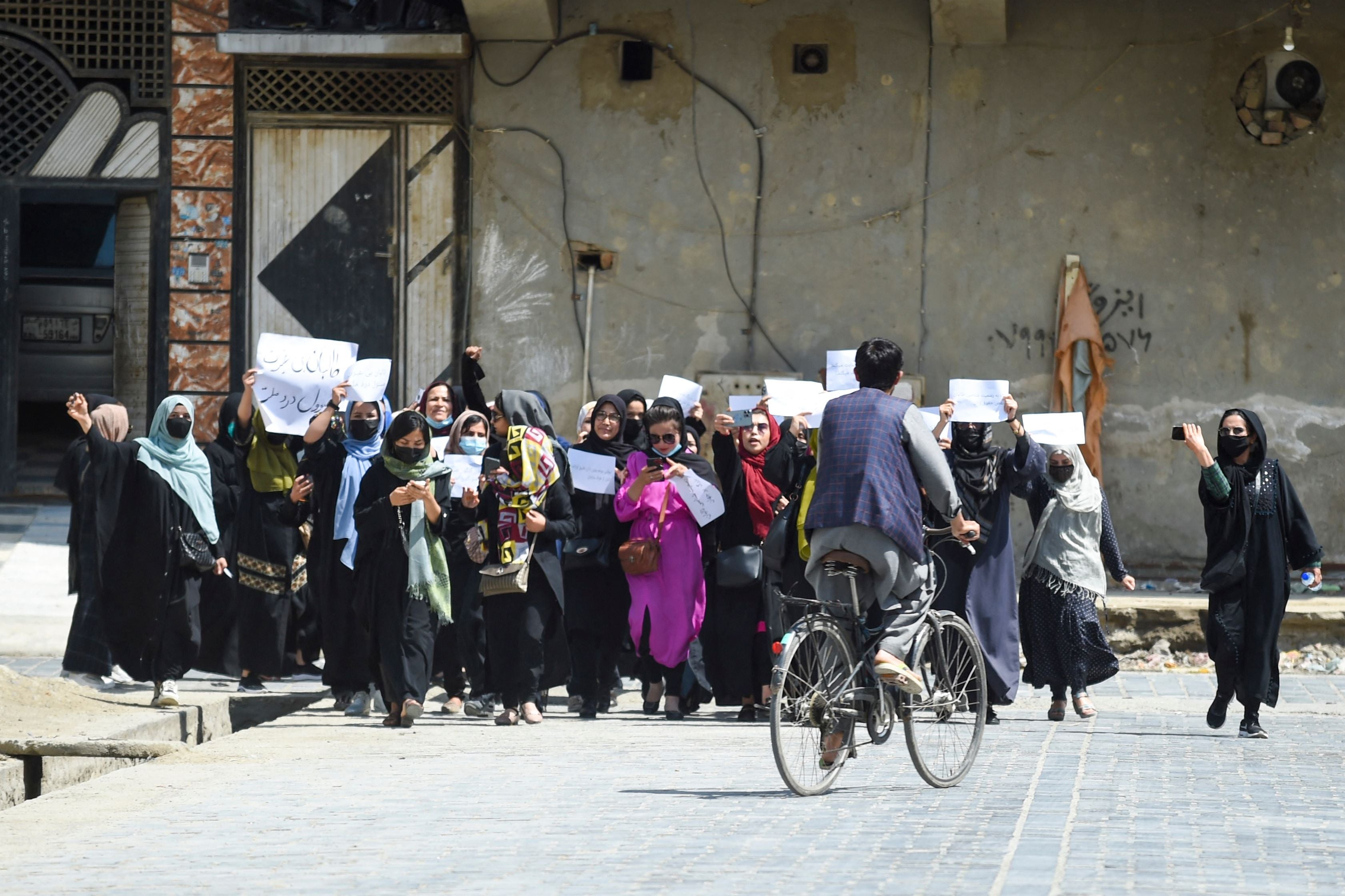 Afghan women hold placards as they march to protest for their rights, in Kabul