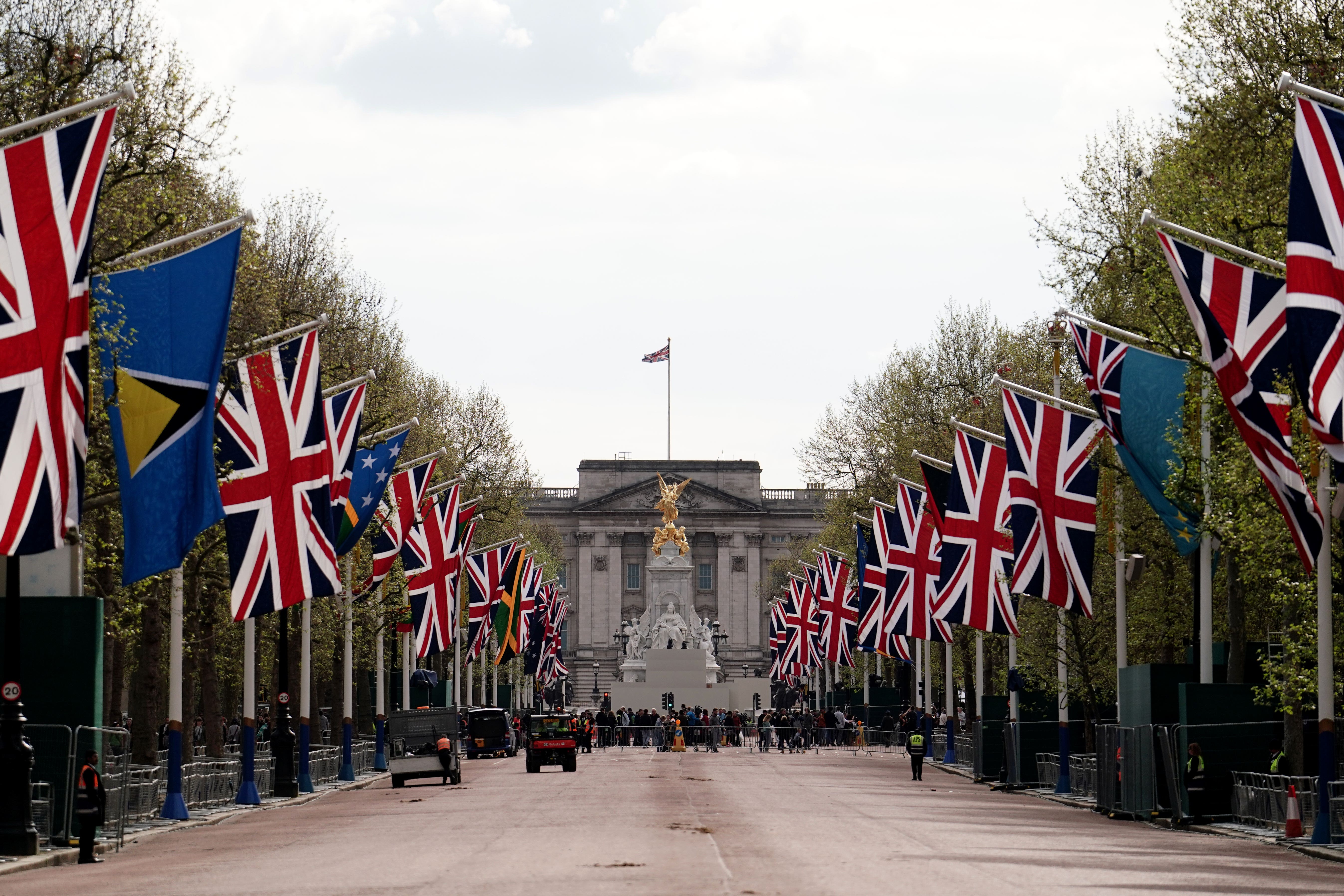 Union flags hang outside Buckingham Palace on the Mall (Jordan Pettitt/PA)