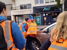 Moment motorist drives through Just Stop Oil protesters blocking road and ‘runs over woman’s foot’