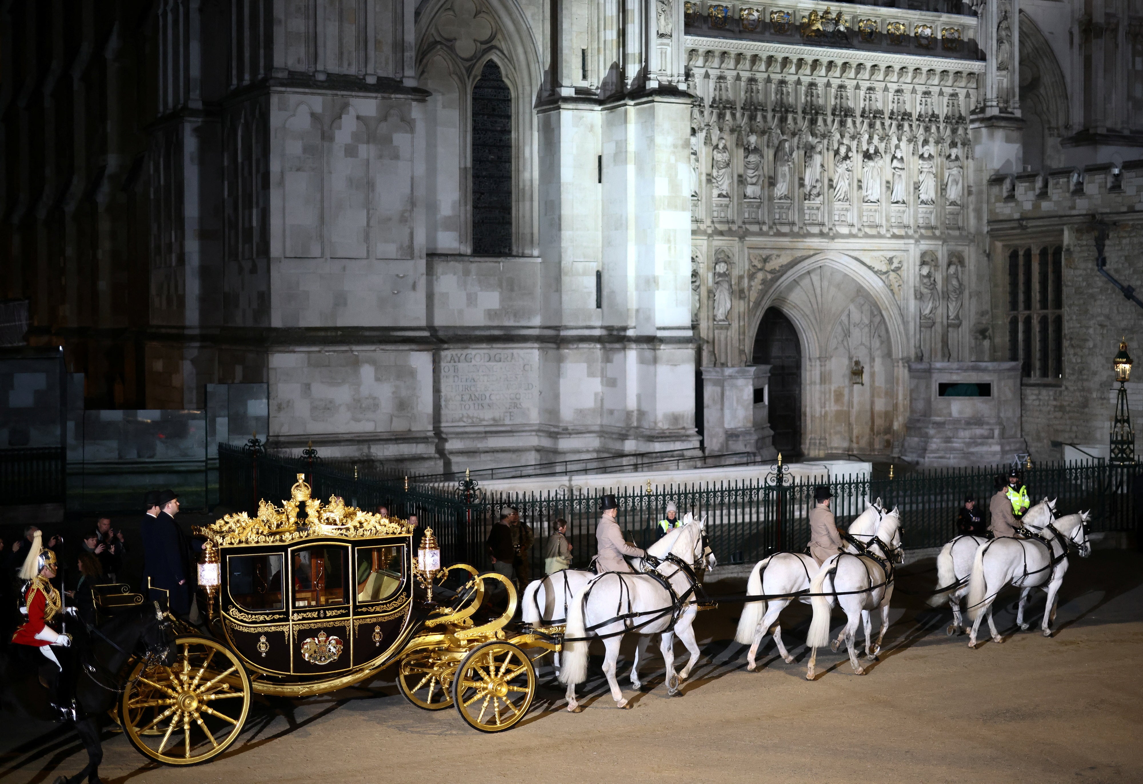 The Diamond Jubilee Coach is ridden alongside members of the military during a full overnight dress rehearsal of the coronation