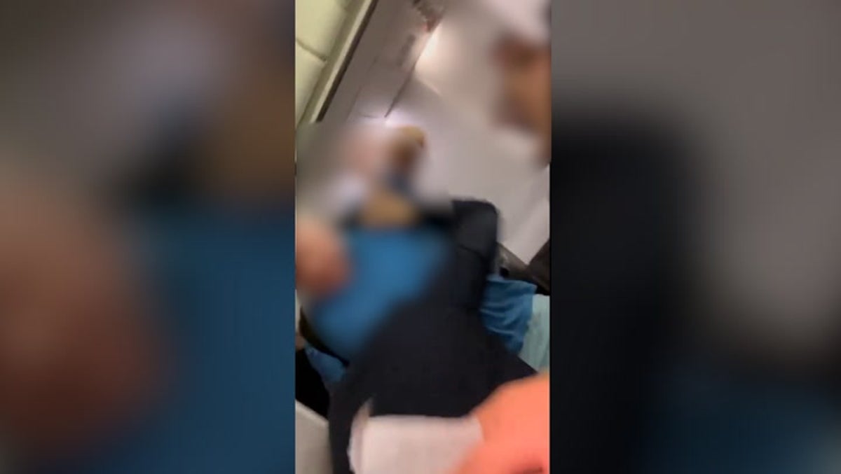 Passenger attempts to punch flight attendant and jump out of plane emergency exit