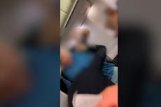 Passenger attempts to punch flight attendant and jump out of plane emergency exit