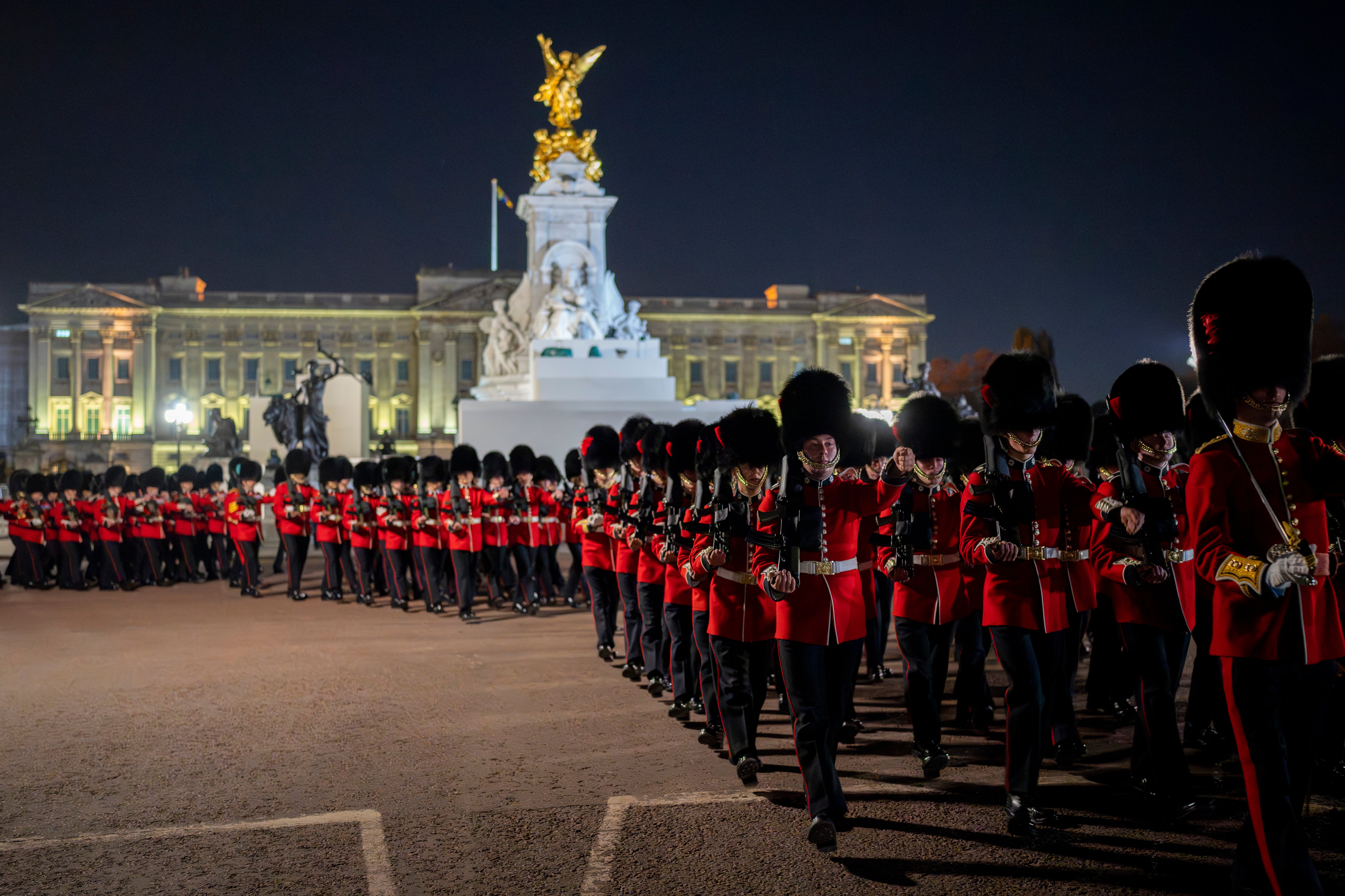 Members of the military march near Buckingham Palace in the coronation rehearsal