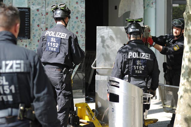<p>Police officers secure evidence during a raid in Saarlouis, Germany</p>