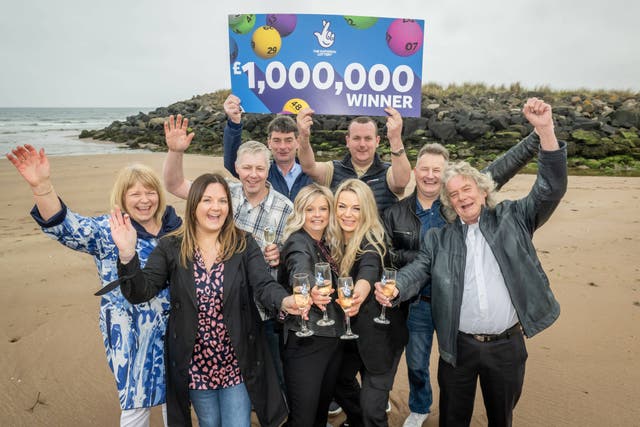 The syndicate members celebrate their Euromillions win (PA)