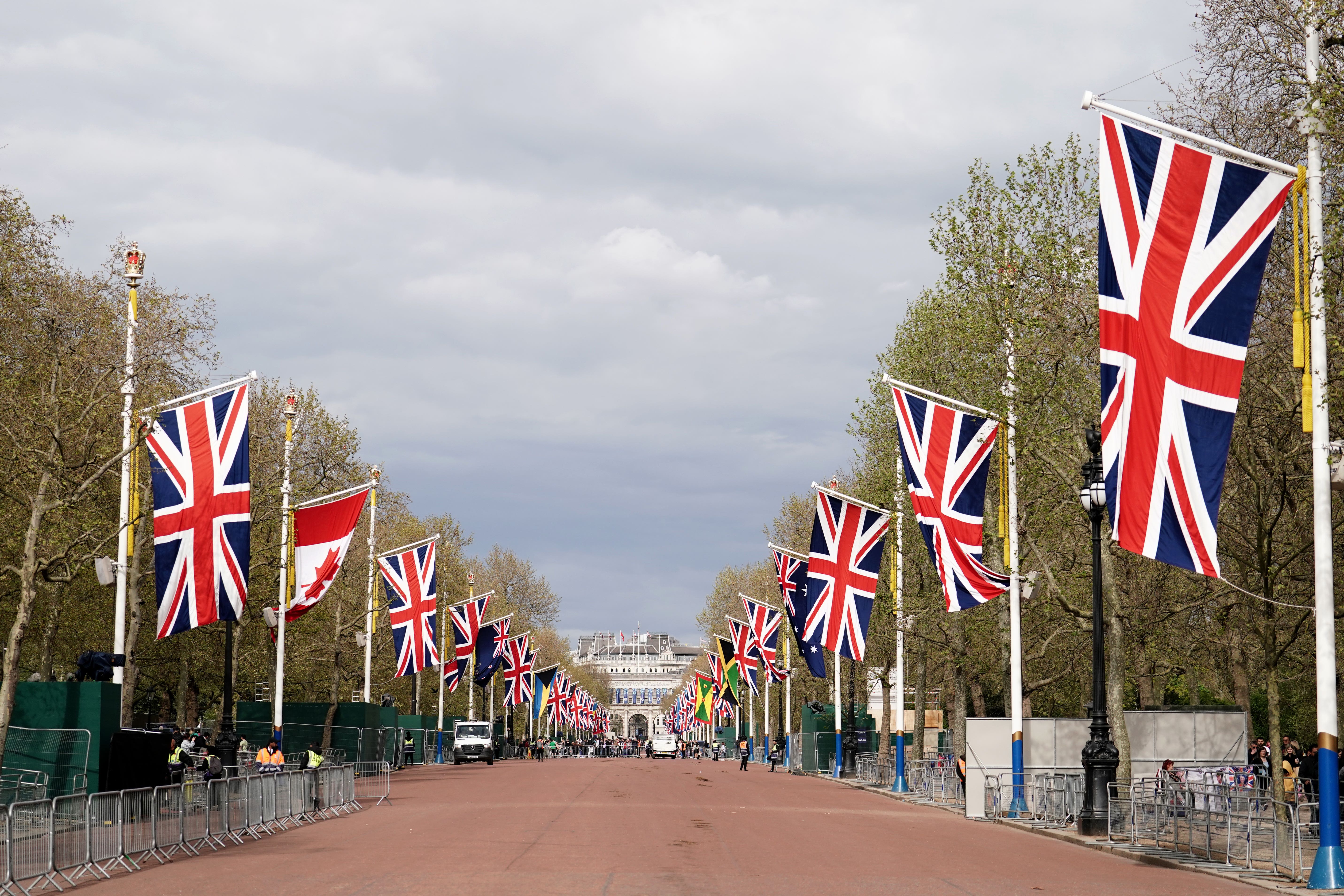 Union flags hang from the street furniture outside Buckingham Palace on the Mall (Jordan Pettitt/PA)