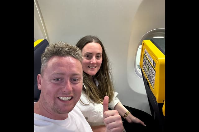 <p>Mark Bowe and his wife on their flight to Ibiza</p>