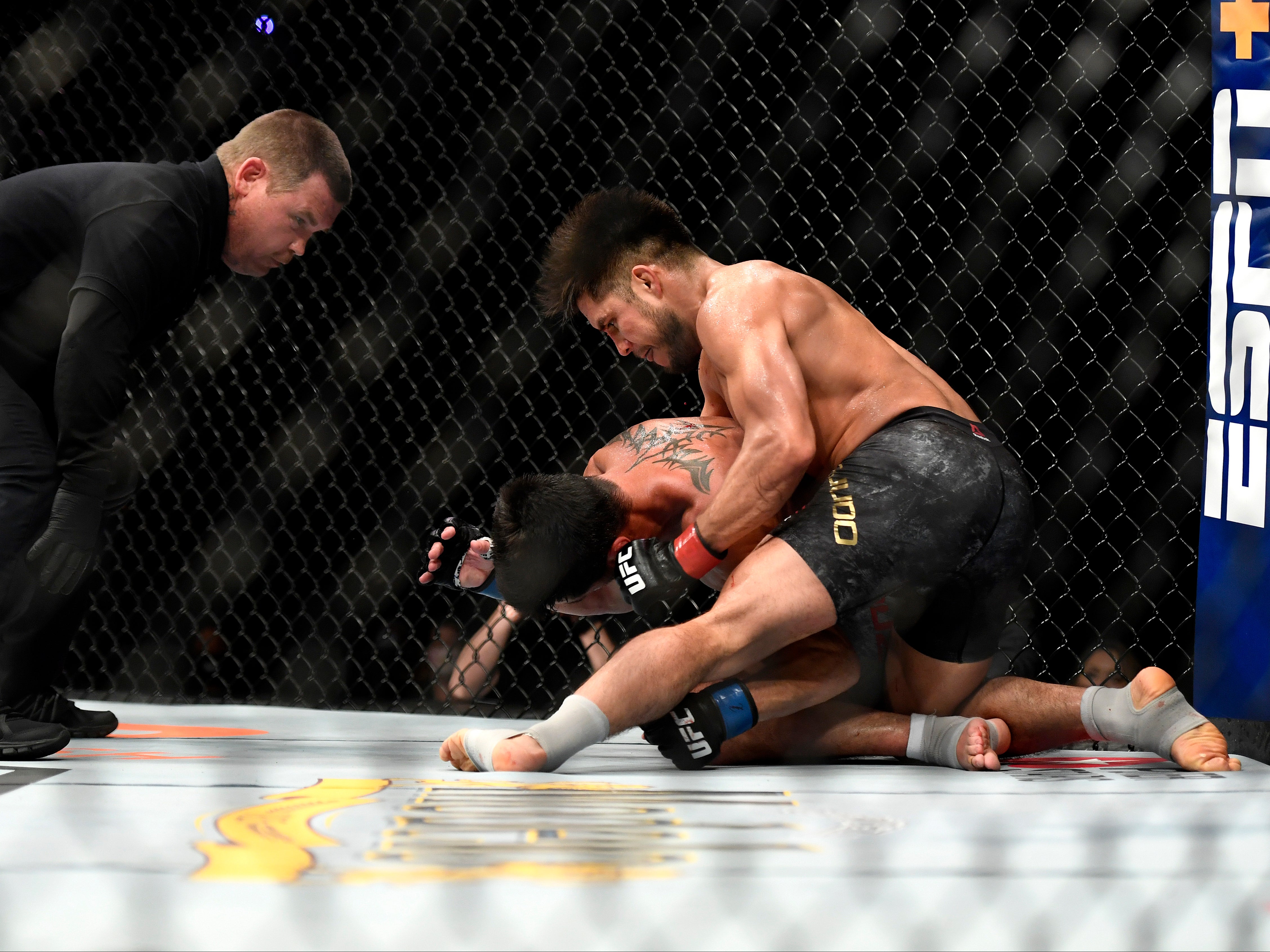 Cejudo (right) retained the bantamweight belt against Dominick Cruz in his last fight before retiring