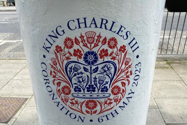 Stickers were plastered over the a coronation postbox in Cardiff city centre (Jonathan McCambridge/PA)