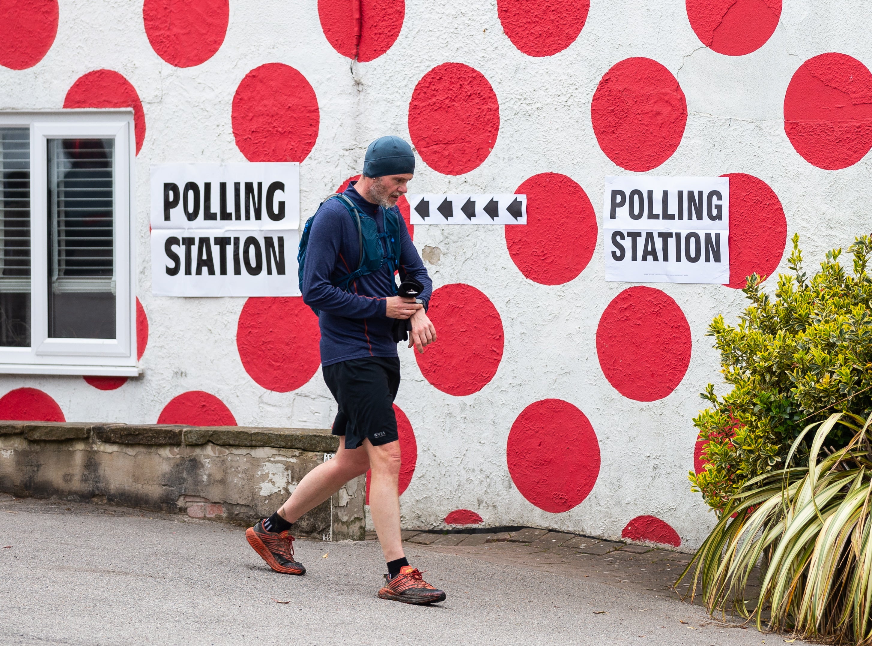 A person walks past a polling station at Langsett Barn in Sheffield, Britain