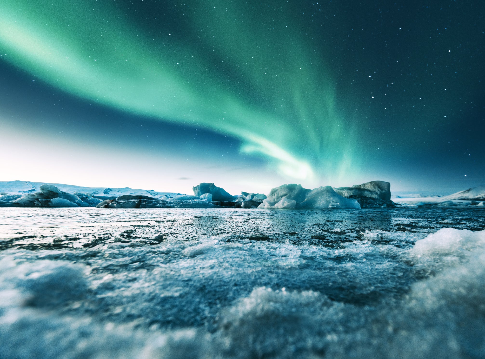 White ice contrasts with the Aurora Borealis in Jokulsarlon