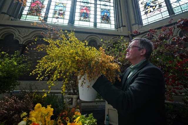 Florist Shane Connolly, who will be arranging the flowers within Westminster Abbey, holding wild broom from the Isle of Skye in Scotland, which forms part of the coronation service flowers, at Chapter House, Westminster Abbey (Yui Mok/PA)