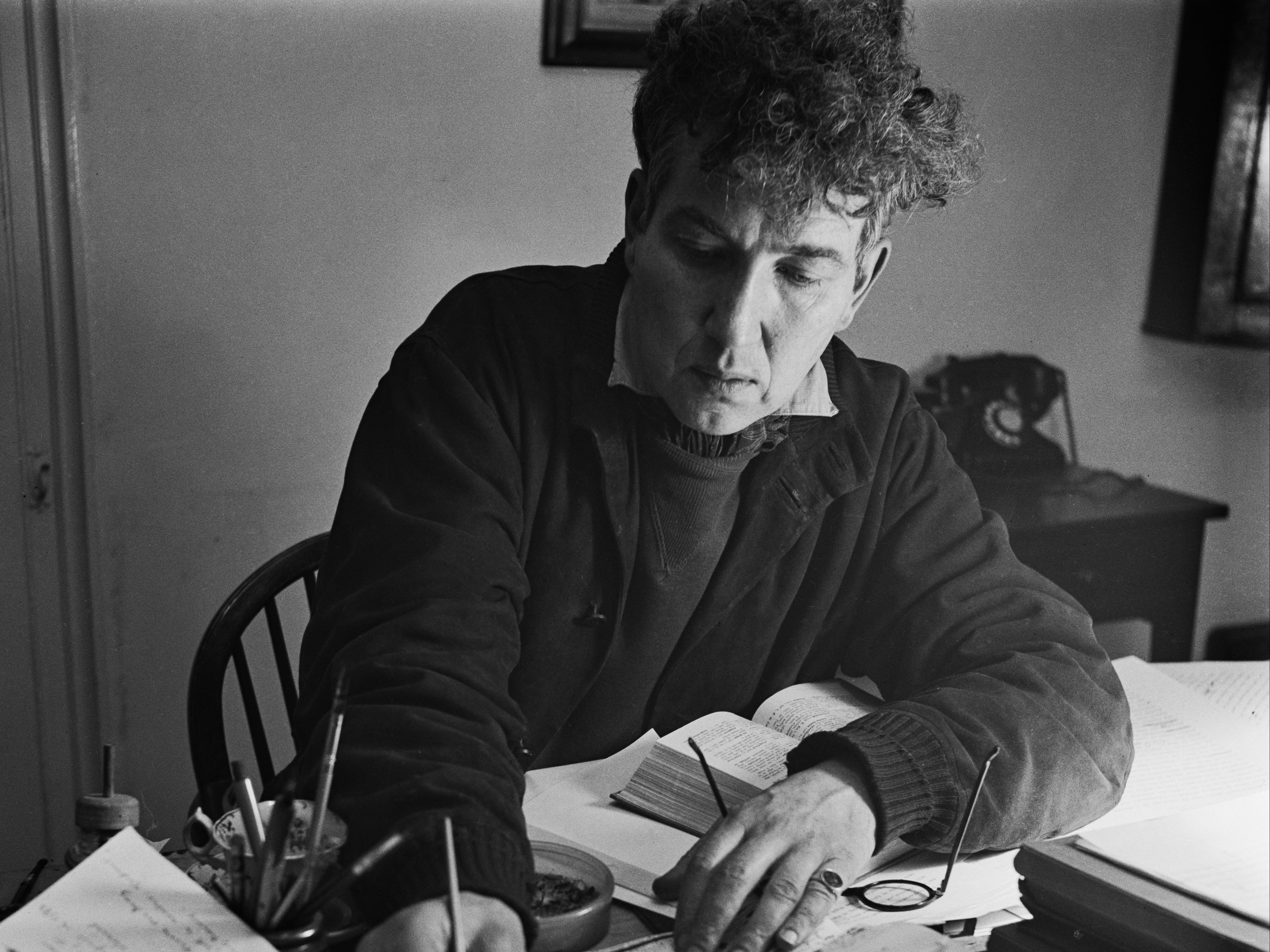 Robert Graves writing at Vale House, his home in Galmpton near Brixham, Devon, in December 1941