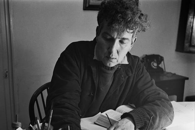 <p>Robert Graves writing at Vale House, his home in Galmpton near Brixham, Devon, in December 1941</p>