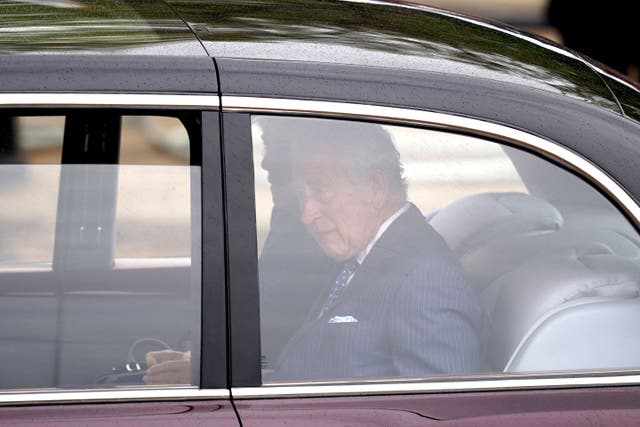 King Charles III and Queen Camilla arrive by car at Buckingham Palace in London ahead of their coronation (Niall Carson/PA)