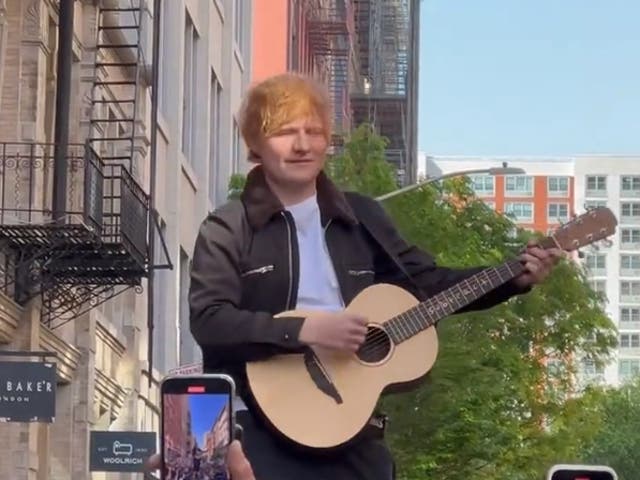 <p>Ed Sheeran performs atop a car in New York</p>