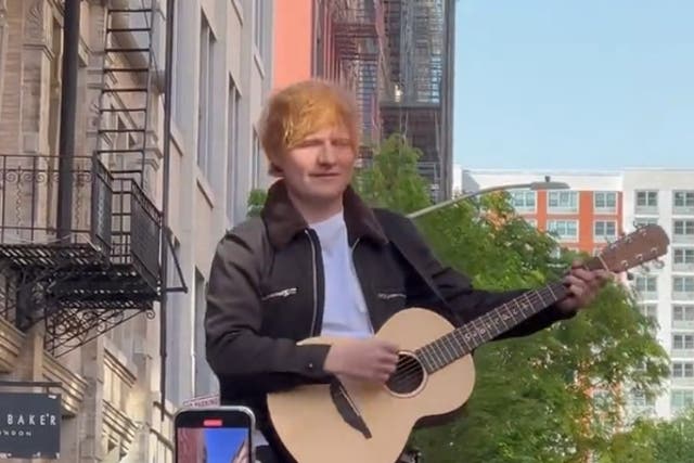 <p>Ed Sheeran performs atop a car in New York</p>