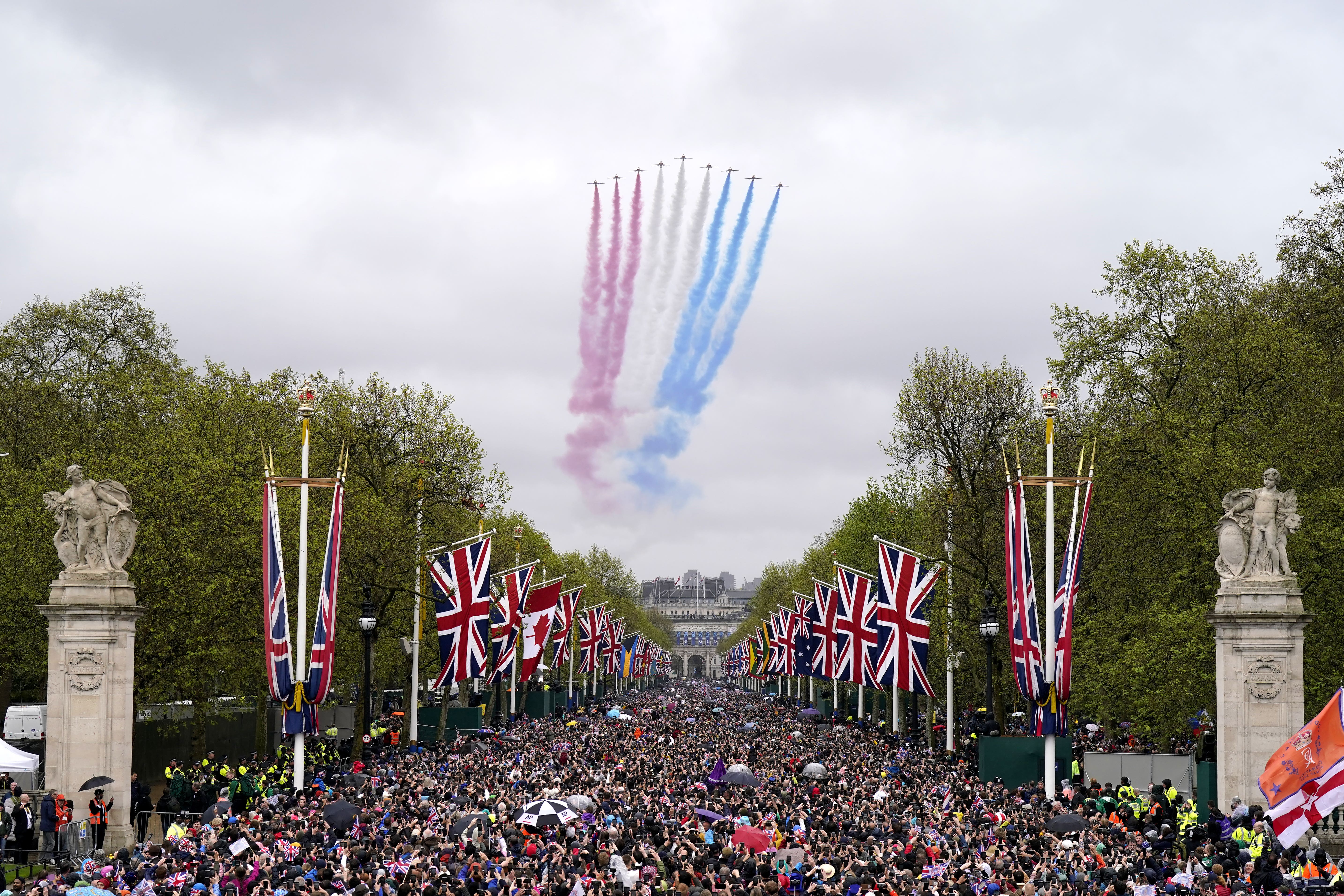 Red Arrows fly over the Mall following the coronation of King Charles III and Queen Camilla