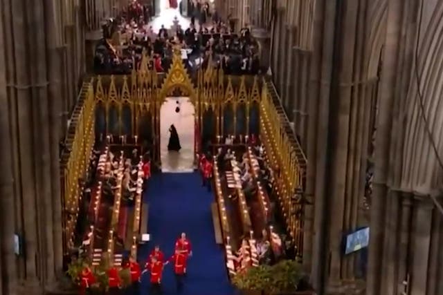 <p>Moment mysterious cloaked figure runs past Westminster Abbey during coronation</p>