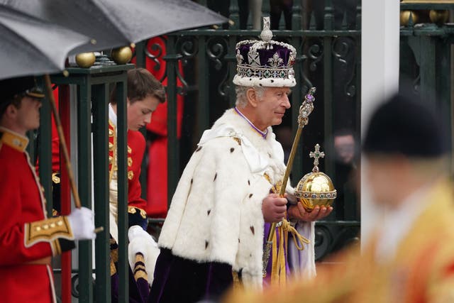 The King, wearing the Imperial State Crown, leaves Westminster Abbey (Joe Giddens/PA)