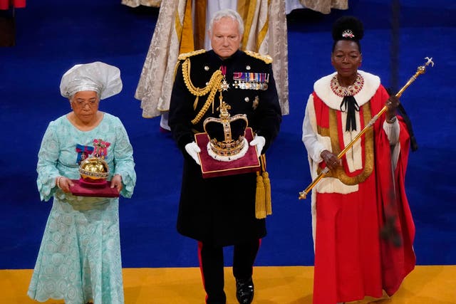 <p>Baroness Floella Benjamin (R), carrying the the Sovereign’s Sceptre with Dove, General Sir Gordon Messenger, (C) the Governor of HM Tower of London, carrying St Edward’s Crown as Lord High Steward of England, and Dame Elizabeth Anionwu (L) </p>