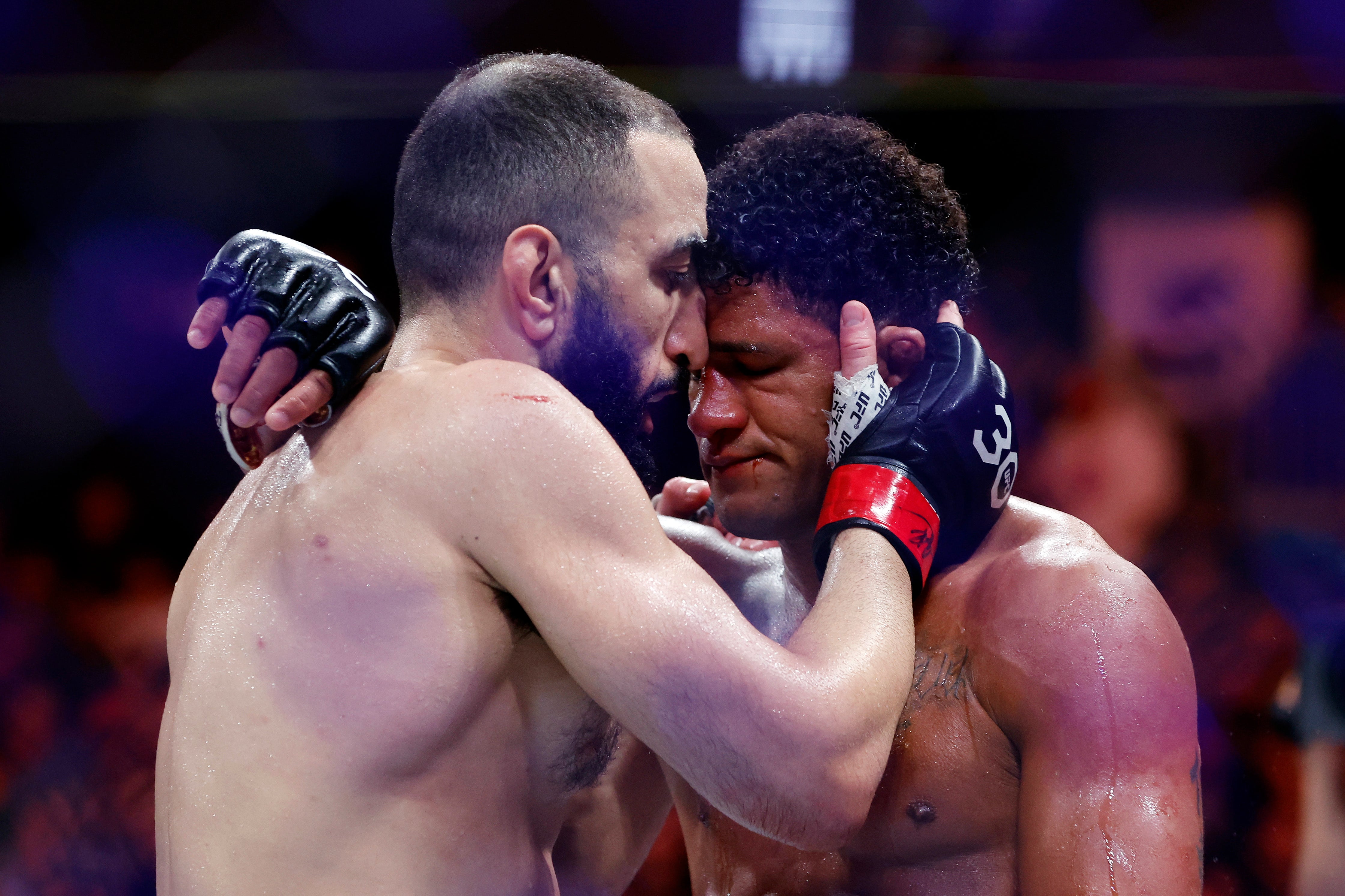 Belal Muhammad (left) consoles Gilbert Burns after outpointing the injured Brazilian