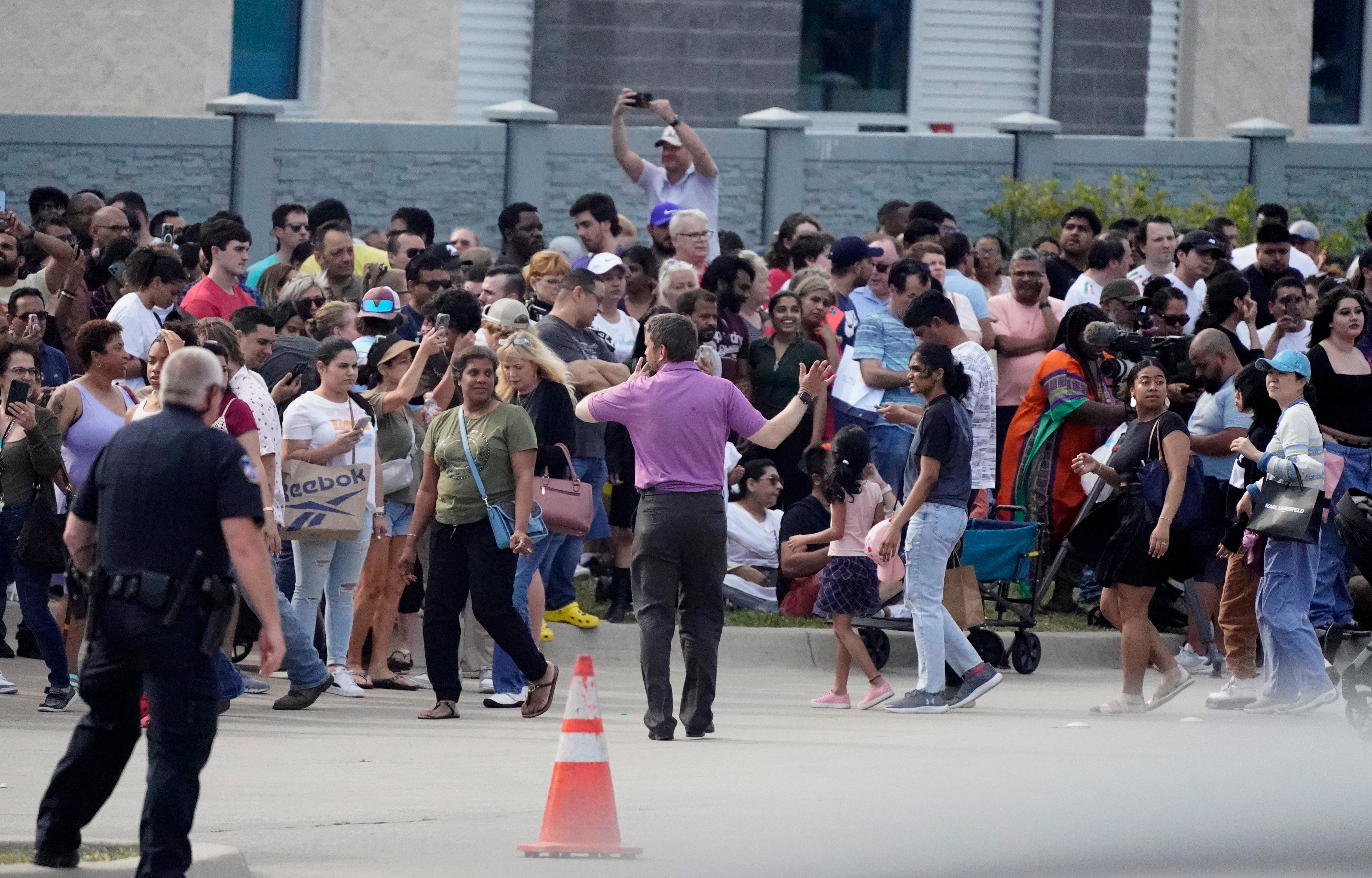 Hundreds of shoppers exiting the Allen Premium Outlets after a mass shooting on Saturday.