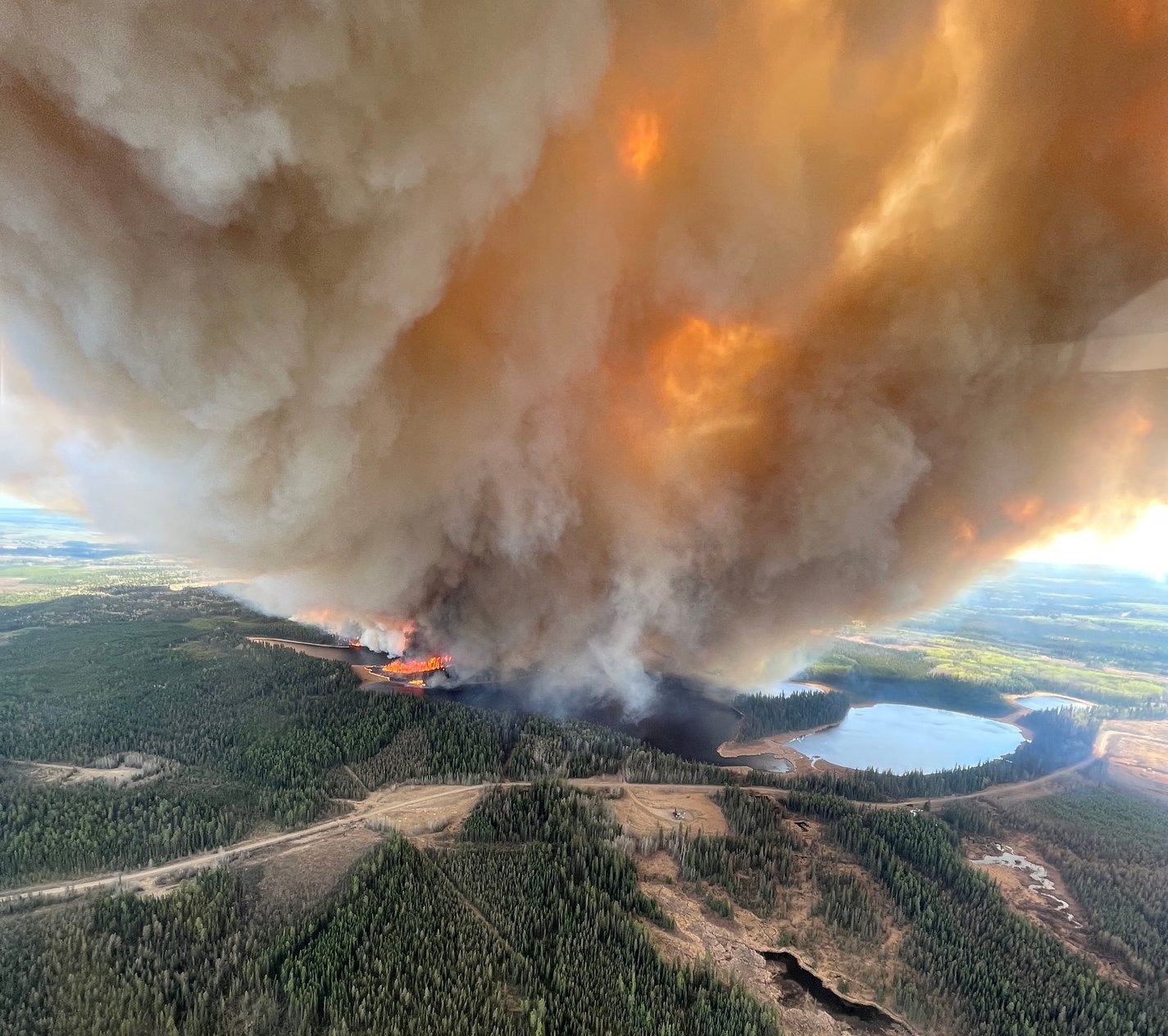 A smoke column rises from a wildfire near Lodgepole, Alberta, Canada on 4 May