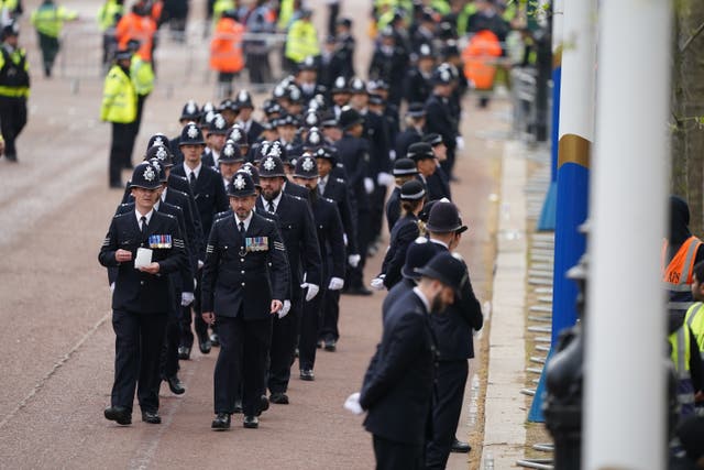 Police officers arrive to line the streets ahead of the coronation ceremony (James Manning/PA)