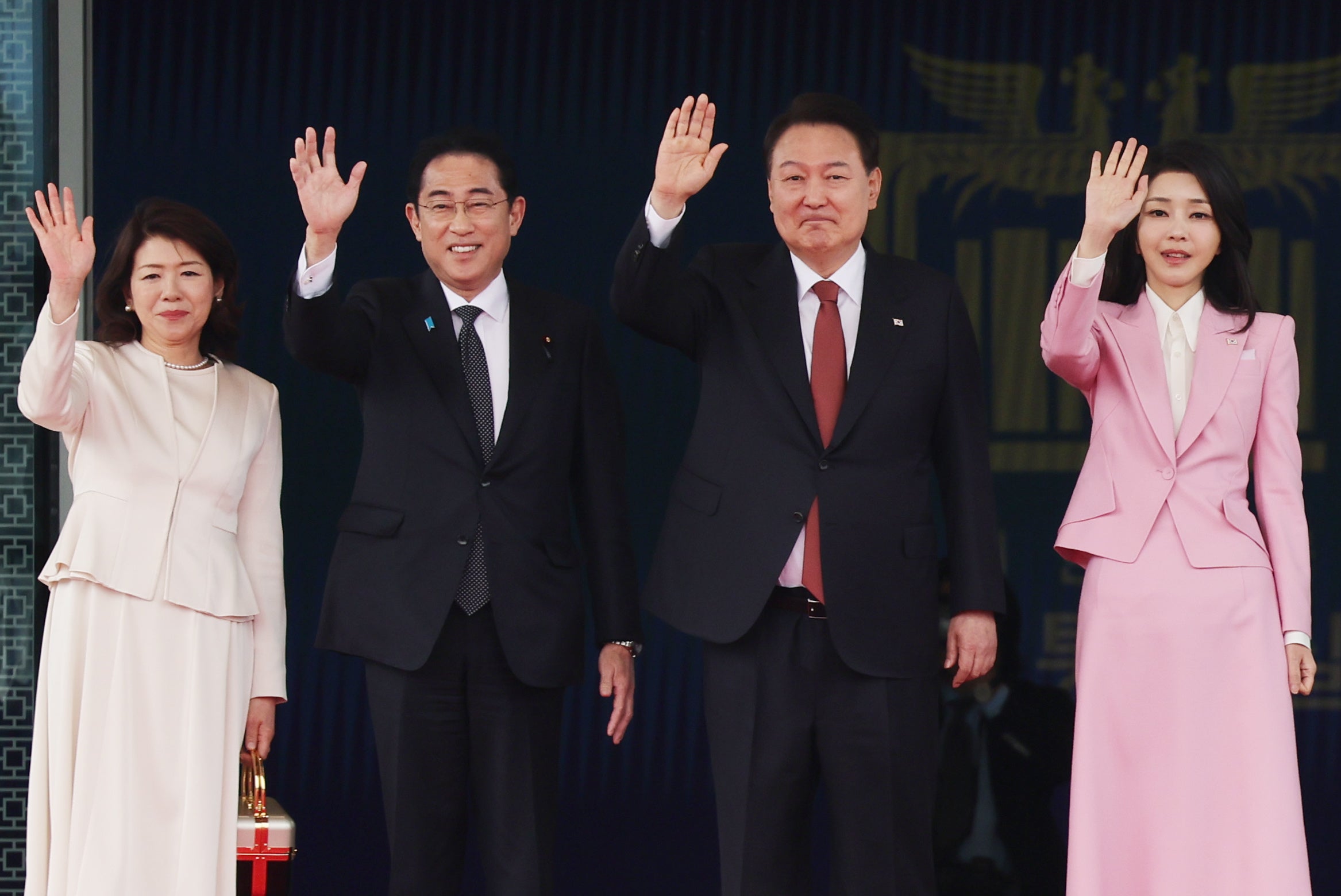 Yoon and his wife Kim Keon Hee wave with Kishida and wife Yuko