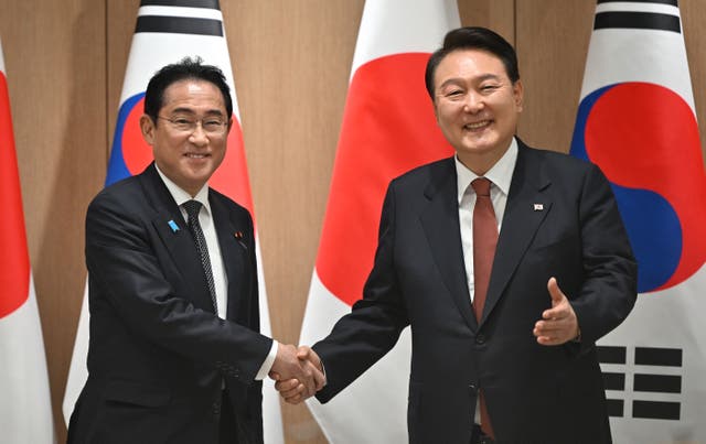 <p>Yoon Suk Yeol shakes hands with Fumio Kishida (left) during their meeting at the former’s presidential office </p>
