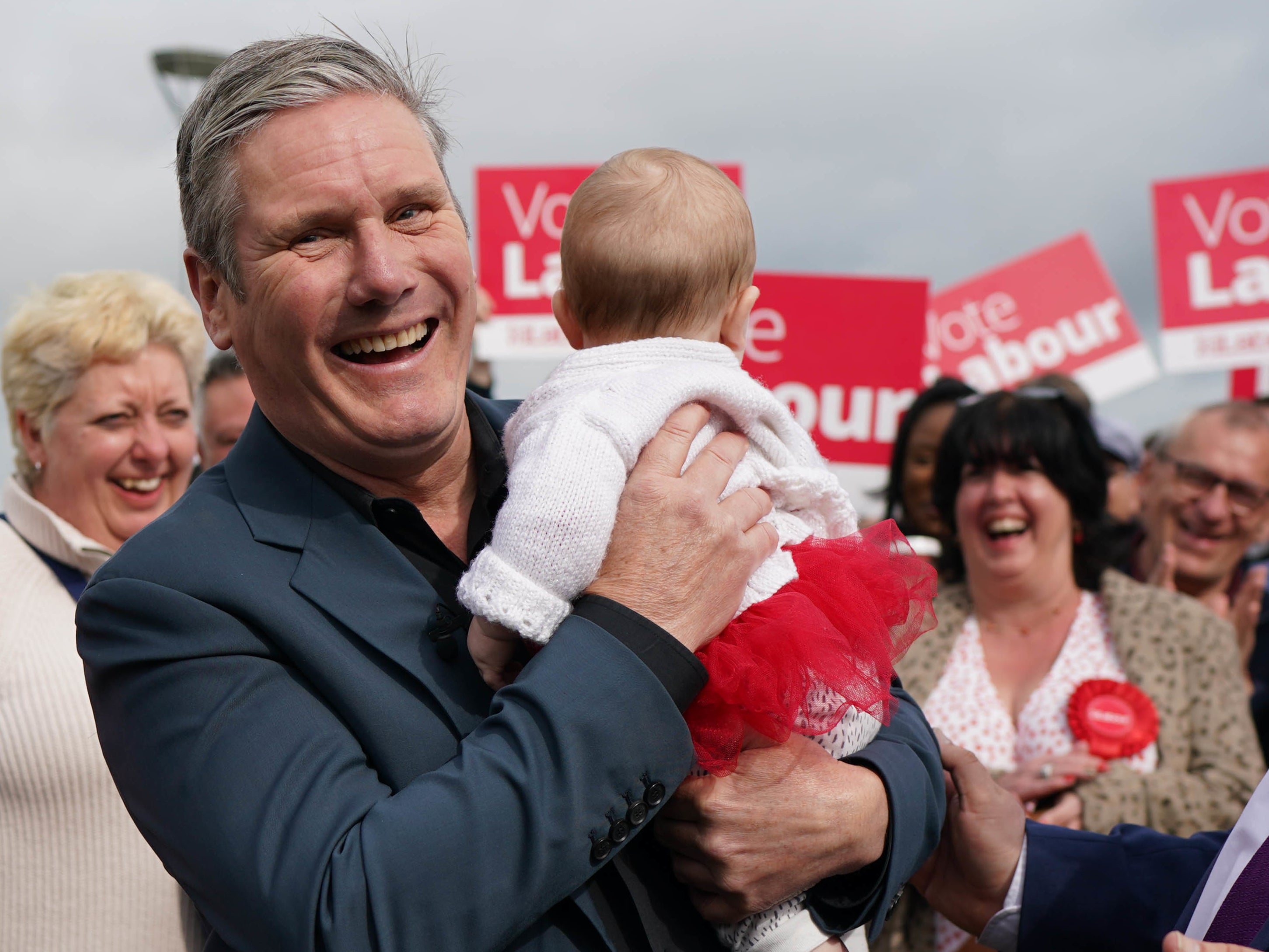 Sir Keir Starmer holds five month old Hazel in Chatham, Kent, after the party won Medway Council