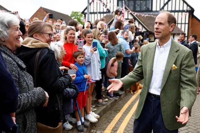 The Duke of Edinburgh greets people as he arrives to attend the Coronation Big Lunch in Cranleigh, Surrey. Thousands of people across the country are celebrating the Coronation Big Lunch on Sunday to mark the crowning of King Charles III and Queen Camilla. Picture date: Sunday May 7, 2023.