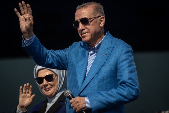 <p>Turkey’s president Recep Tayyip Erdogan and his wife Emine Erdogan greets to supporters during a AK Parti election rally on 7 May in Istanbul</p>