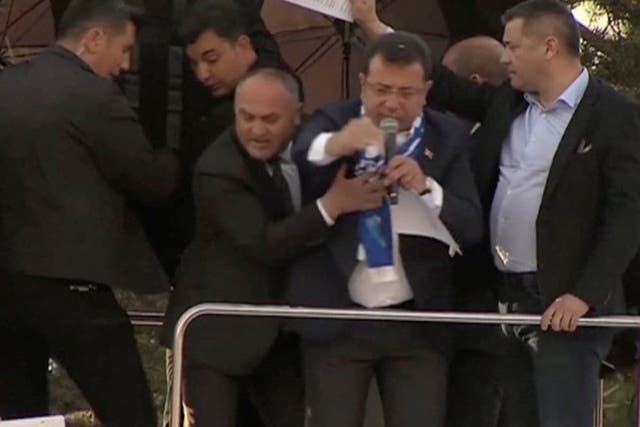 <p>Television cameras capture the moment Istanbul mayor Ekrem Imamoglu of the CHP is pelted with stones in Erzurum, Turkey on Sunday</p>