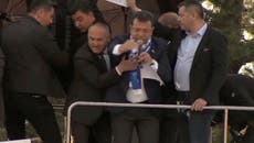Turkish opposition leader forced to flee rally after protesters pelt stones at campaign bus