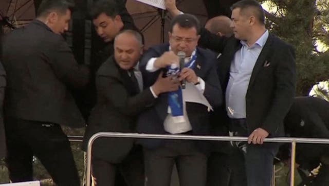 <p>Television cameras capture the moment Istanbul mayor Ekrem Imamoglu of the CHP is pelted with stones in Erzurum, Turkey, on Sunday</p>