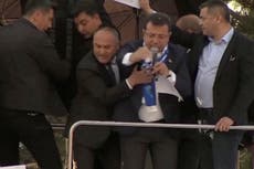 Turkish opposition leader forced to flee rally after protesters pelt stones at campaign bus