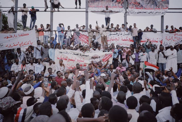 <p>Demonstrators listen to a speech at a protest in Khartoum in 2019 following the overthrow of Omar Hassan al-Bashir</p>