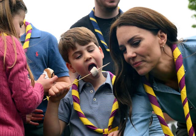 <p>Prince Louis eats toasted marshmallows at a Big Help Out event in Slough</p>