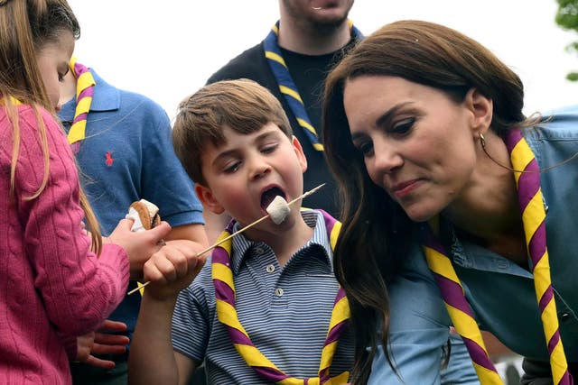 <p>Prince Louis eats toasted marshmallows at a Big Help Out event in Slough</p>