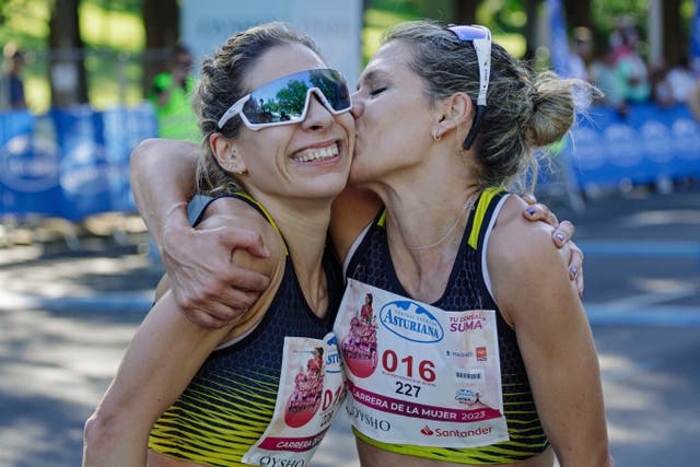<p>Serbia’s Ivana Zagorac, right, is congratulated by her twin sister after winning the amateur women’s running race in Madrid</p>