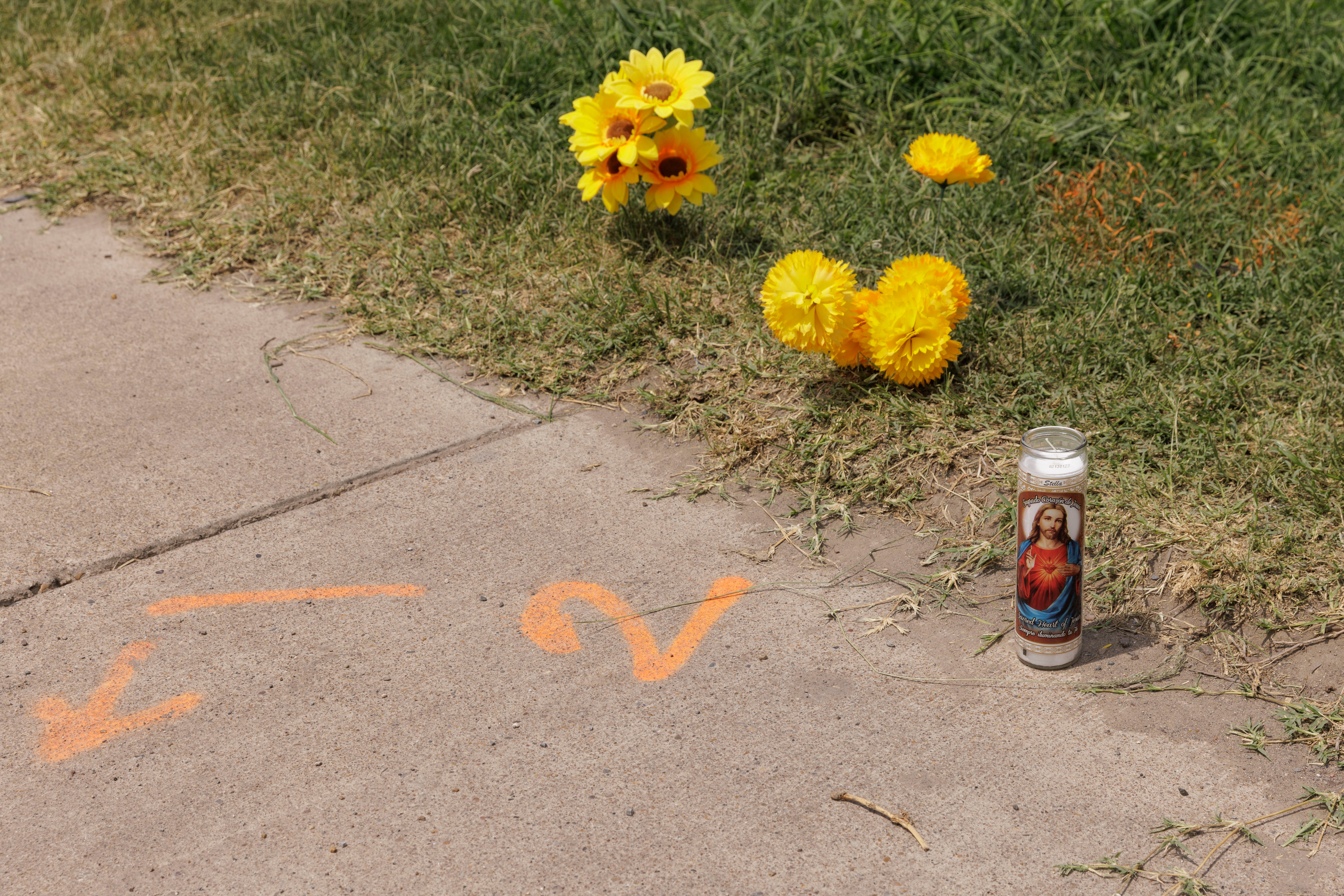 p A votive candle sits next to a spray-painted evidence marker at the site of the deadly crash where eight migrants were run over and killed yesterday waiting at a bus stop on 8 May 2023 in Brownsville, Texas/p