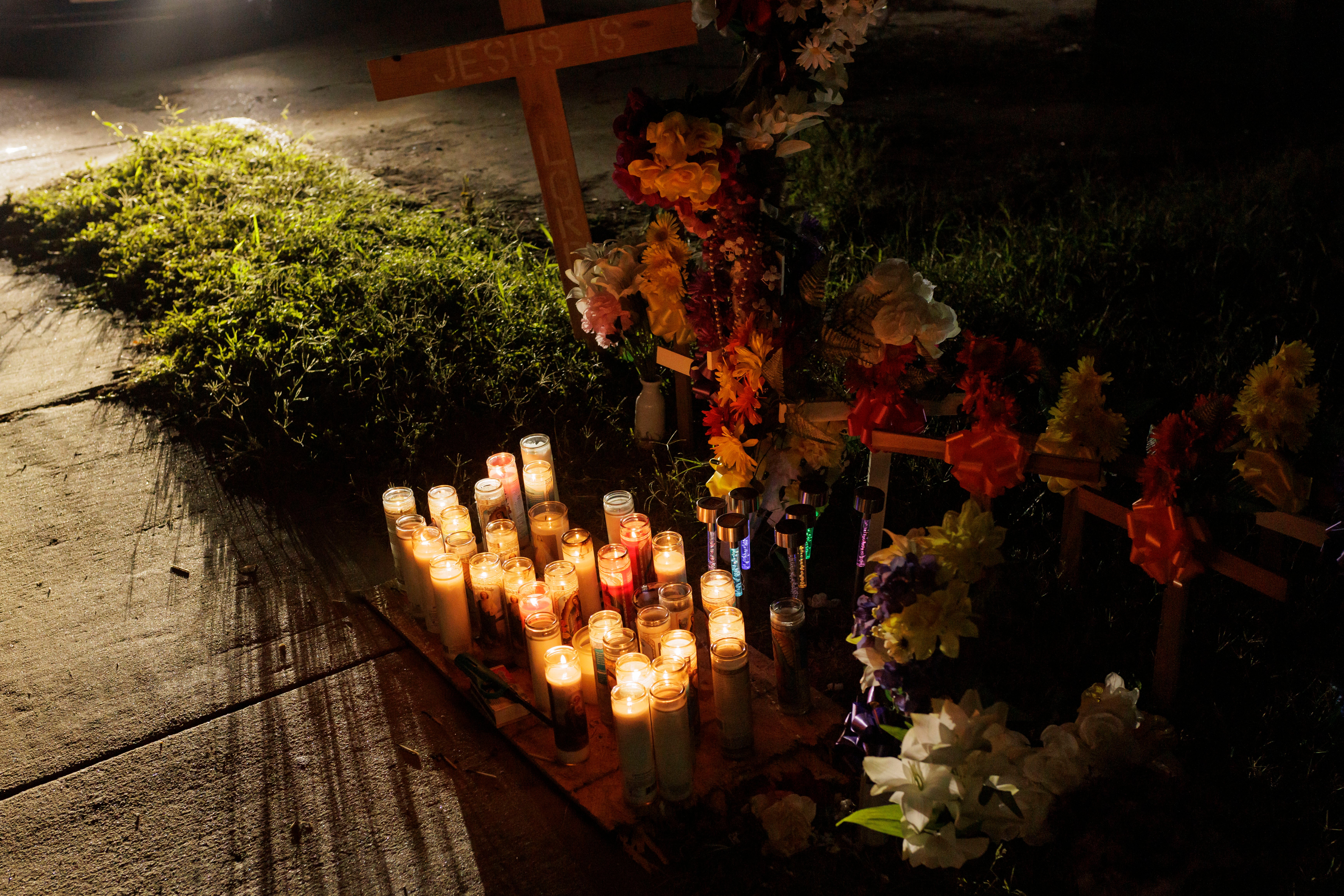 pVotive candles, flowers and crosses setup at a memorial for eight migrants that were run over and killed today waiting at a bus stop on 7 May 2023 in Brownsville, Texas/p