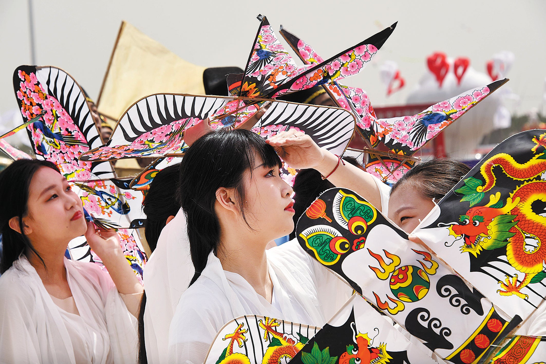 Visitors look to the skies at the kite festival in Weifang