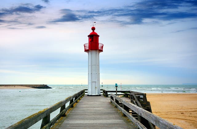 <p>The Lighthouse in Trouville-sur-Mer harbour is a picturesque sight in Normandy </p>