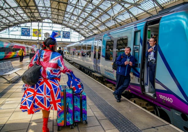 <p>Access all areas? A Eurovision fan arriving at Liverpool Lime Street station ahead of the next round of national rail strikes </p>