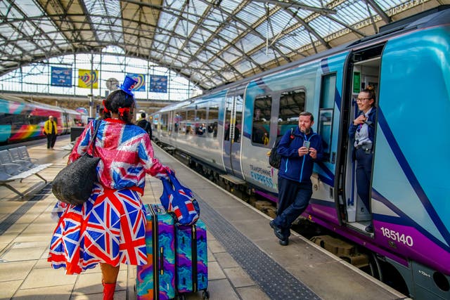 <p>Access all areas? A Eurovision fan arriving at Liverpool Lime Street station ahead of the next round of national rail strikes </p>