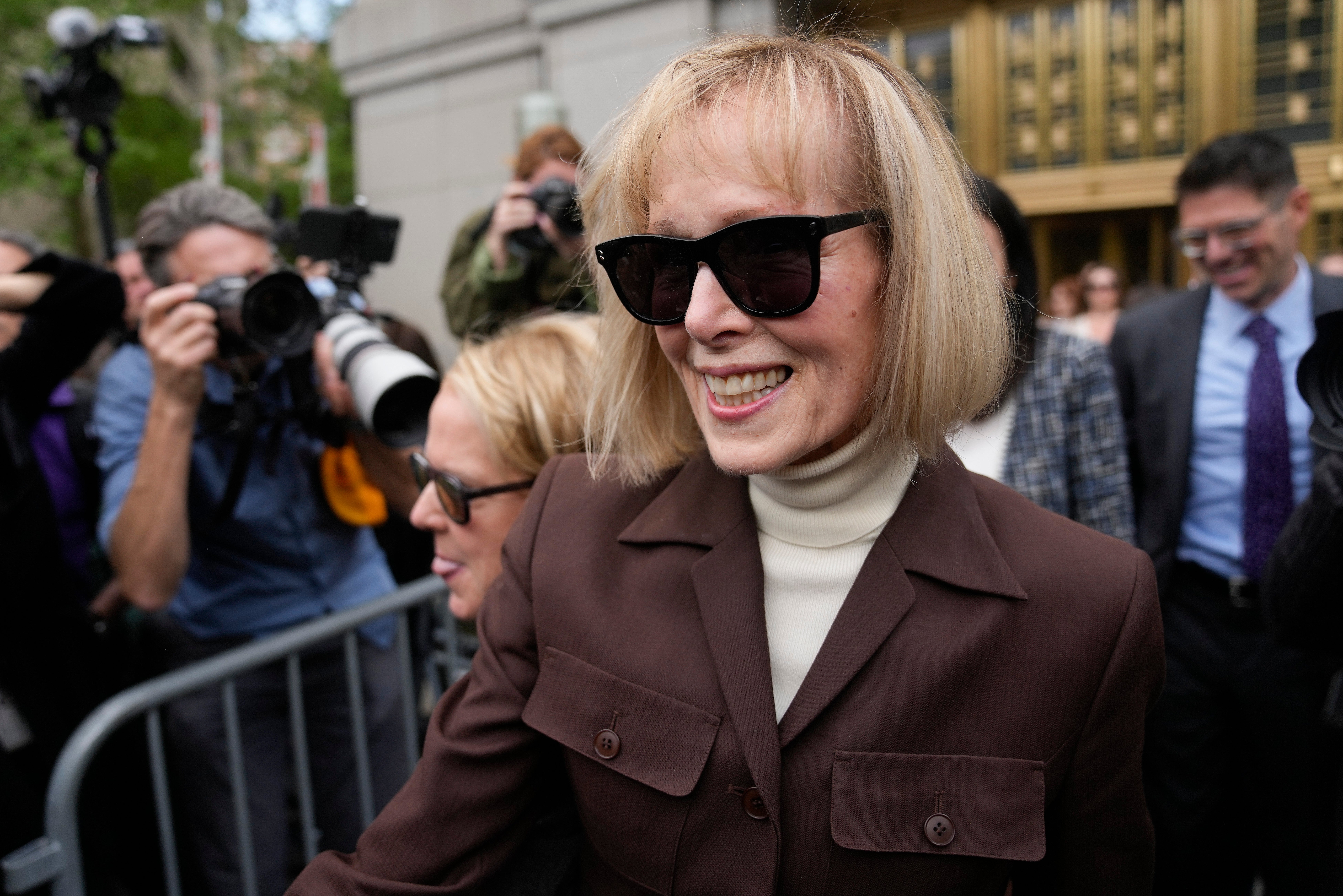 Jean Carroll, center, walks out of Manhattan federal court, on 9 May 2023. A jury has found Donald Trump liable for sexually abusing the advice columnist in 1996, awarding her $5m in a judgment that could haunt the former president as he campaigns to regain the White House.