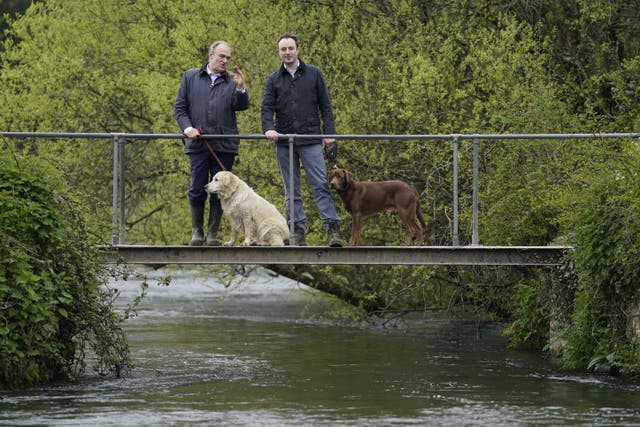 Liberal Democrat leader Sir Ed Davey chats with Danny Chambers during a local dog walk along the River Itchen near Winchester (PA)
